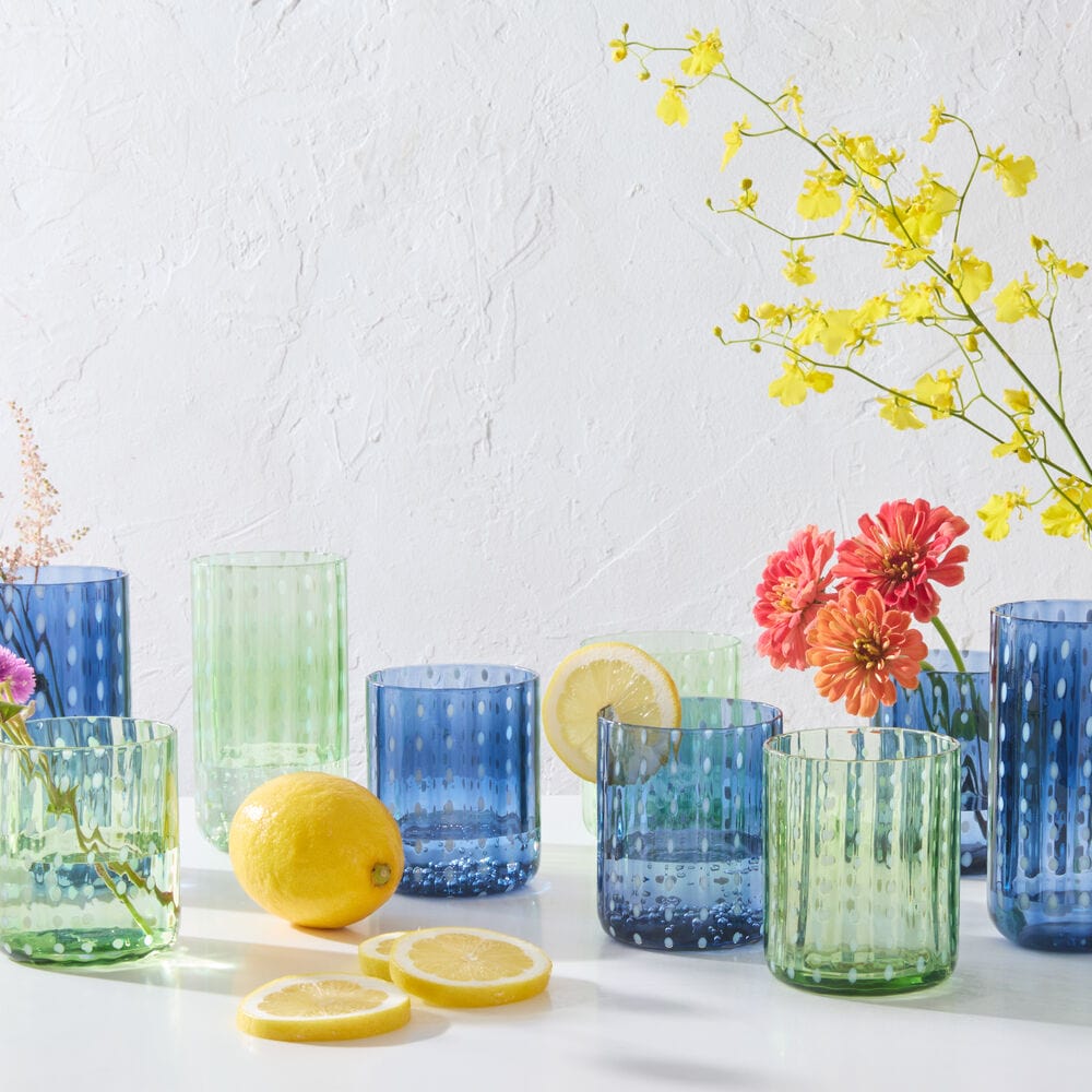 Set of four highball glasses in cobalt, ideal for elegant tableware at dinner parties.