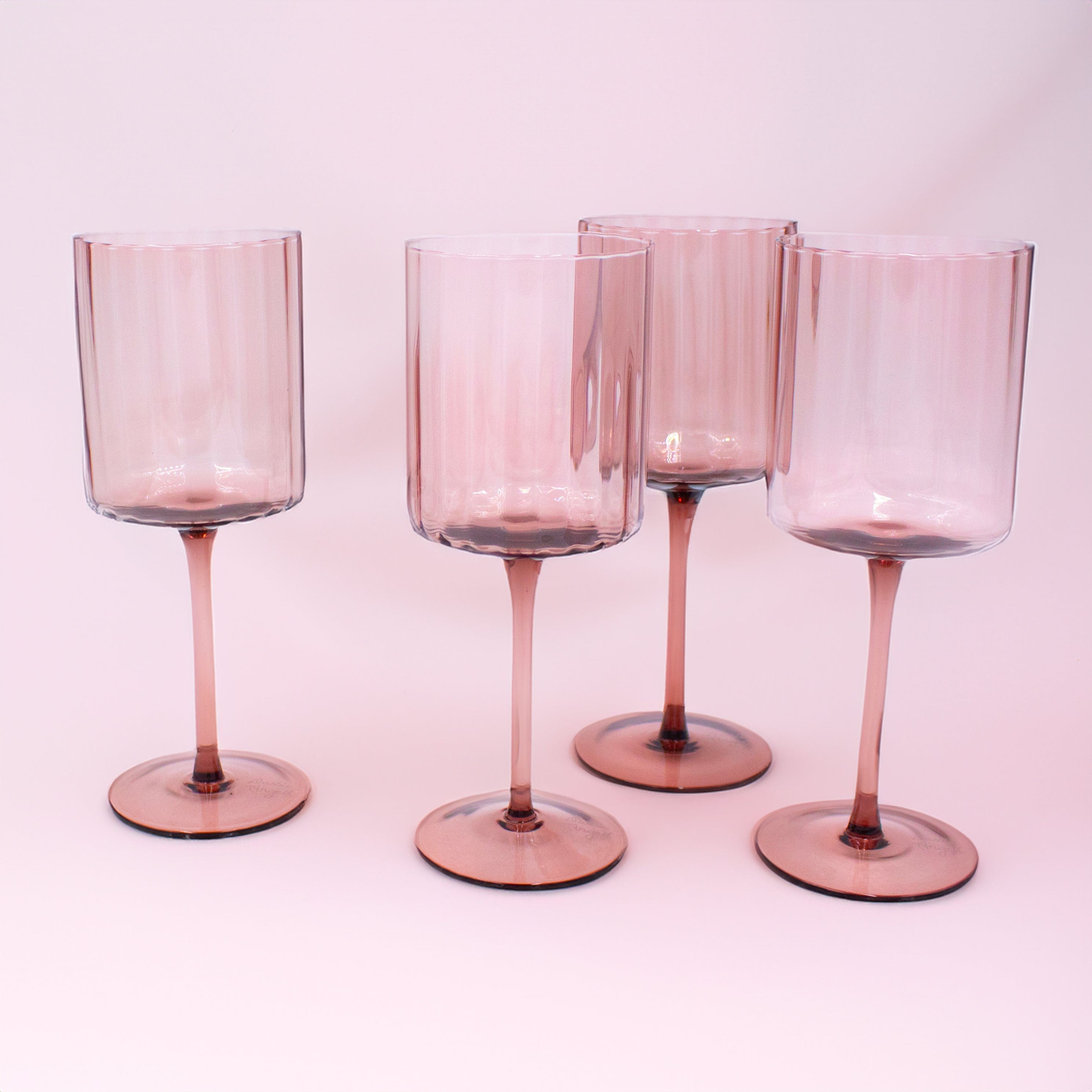 Close-up of prismatic lilac wine glasses with a reflective surface