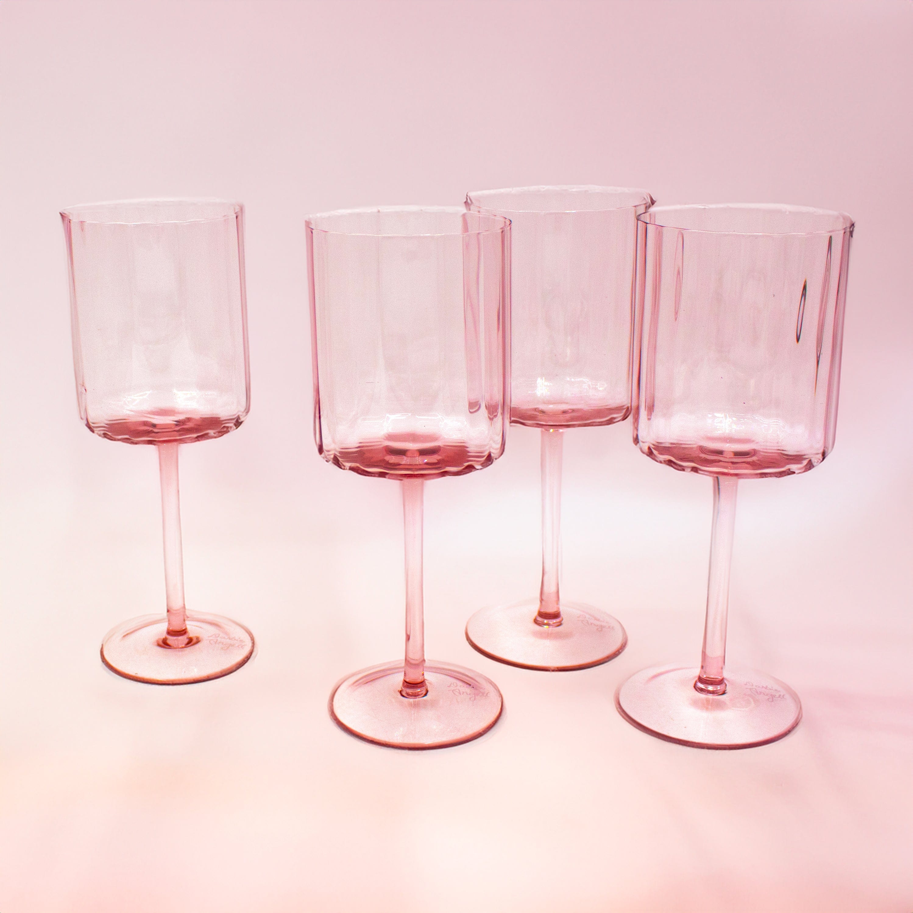Close-up of prismatic blush wine glasses with shimmering effect