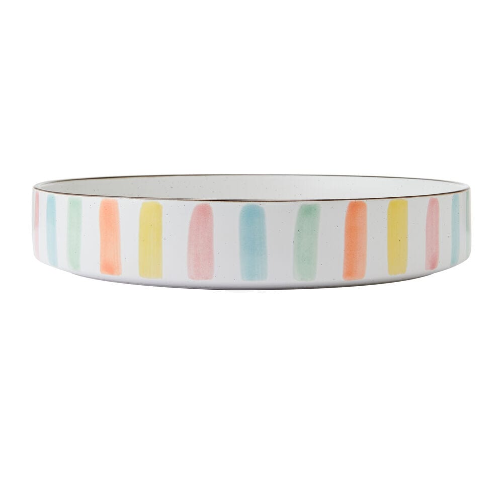 Colorful summer stoneware bowls arranged on a table for entertaining
