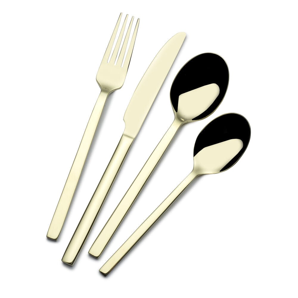 Set of stainless steel flatware for 4 people arranged on a dining table