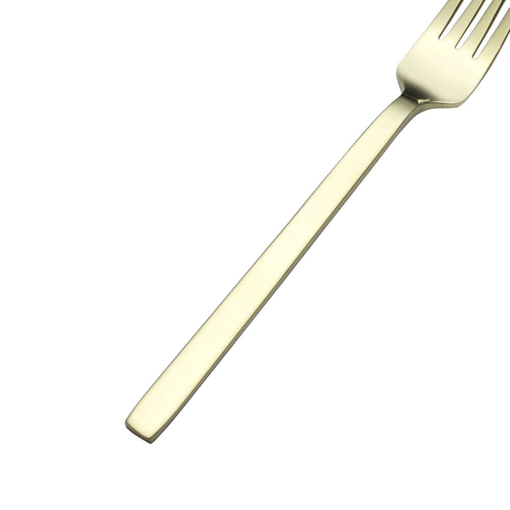 Set of stainless steel flatware for 4 people arranged on a dining table