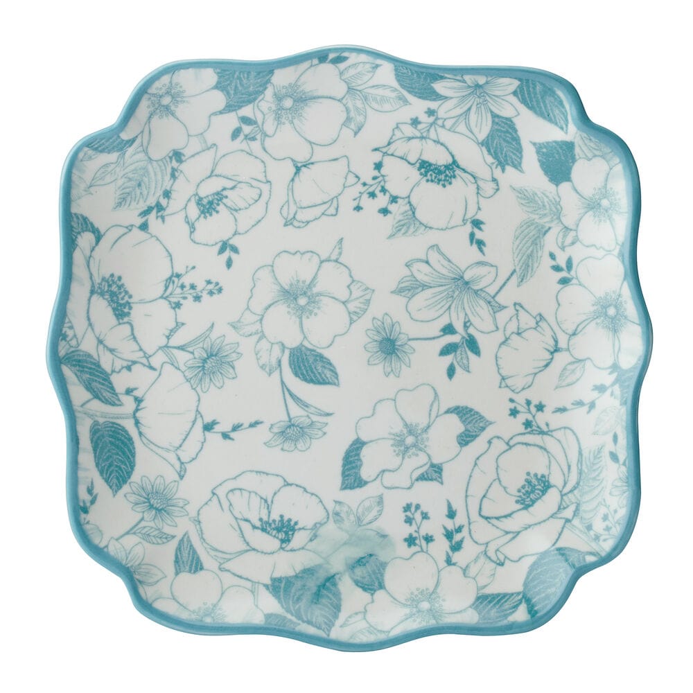 Stacked stoneware dinnerware with scalloped edges and floral pattern