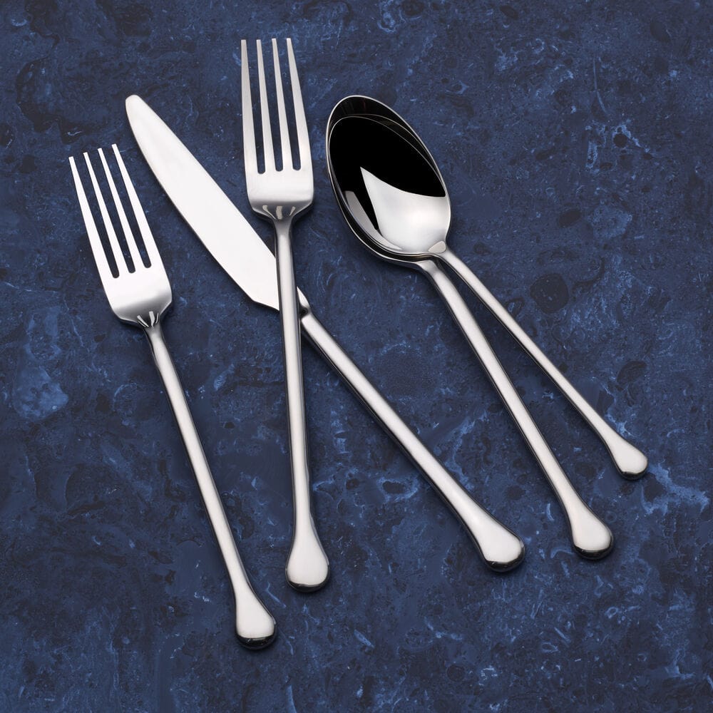 Close-up of Geneva Forged stainless steel flatware set on a modern dining table