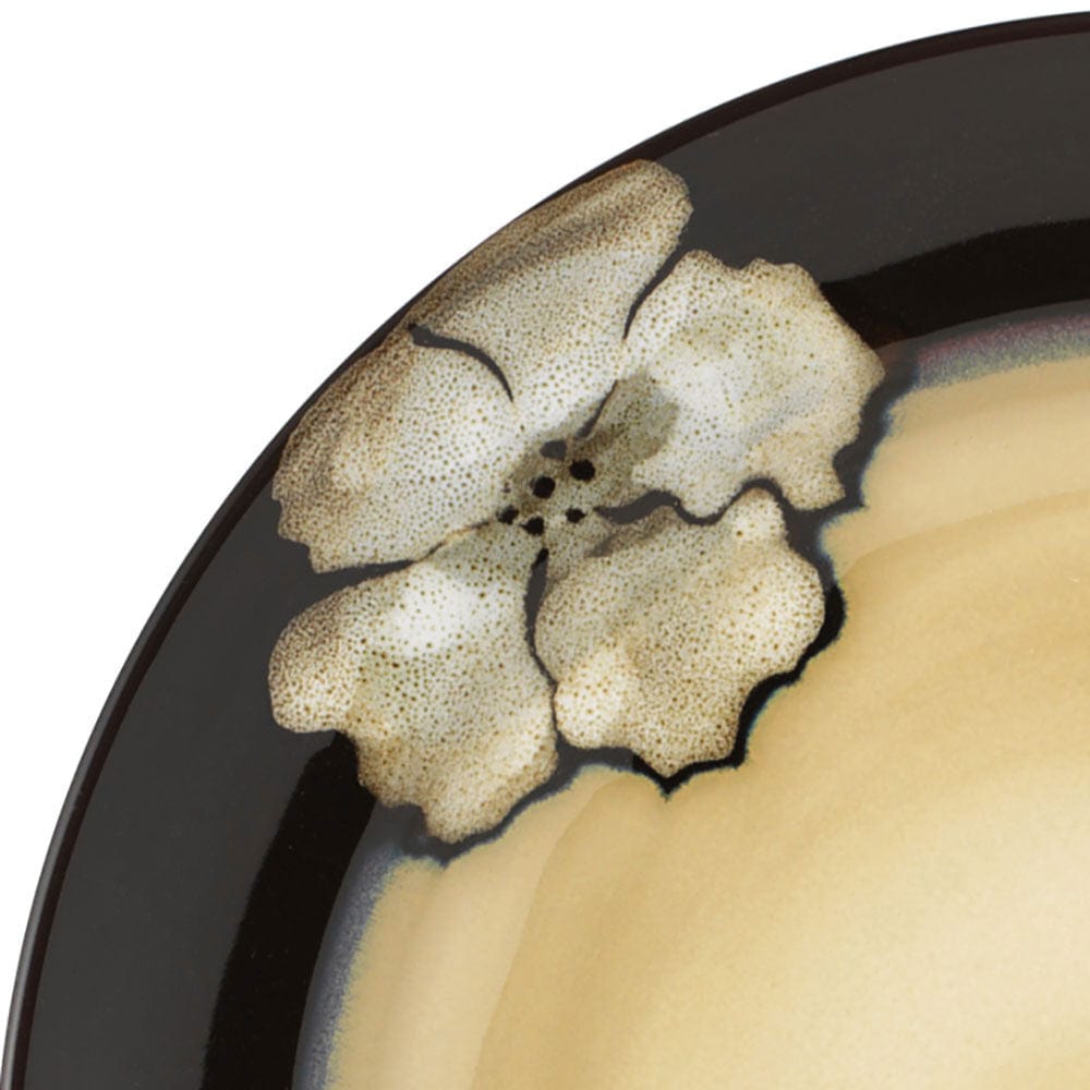 Close-up of serveware set with plates from the Painted Poppies collection, highlighting the vibrant poppy design and glaze texture.