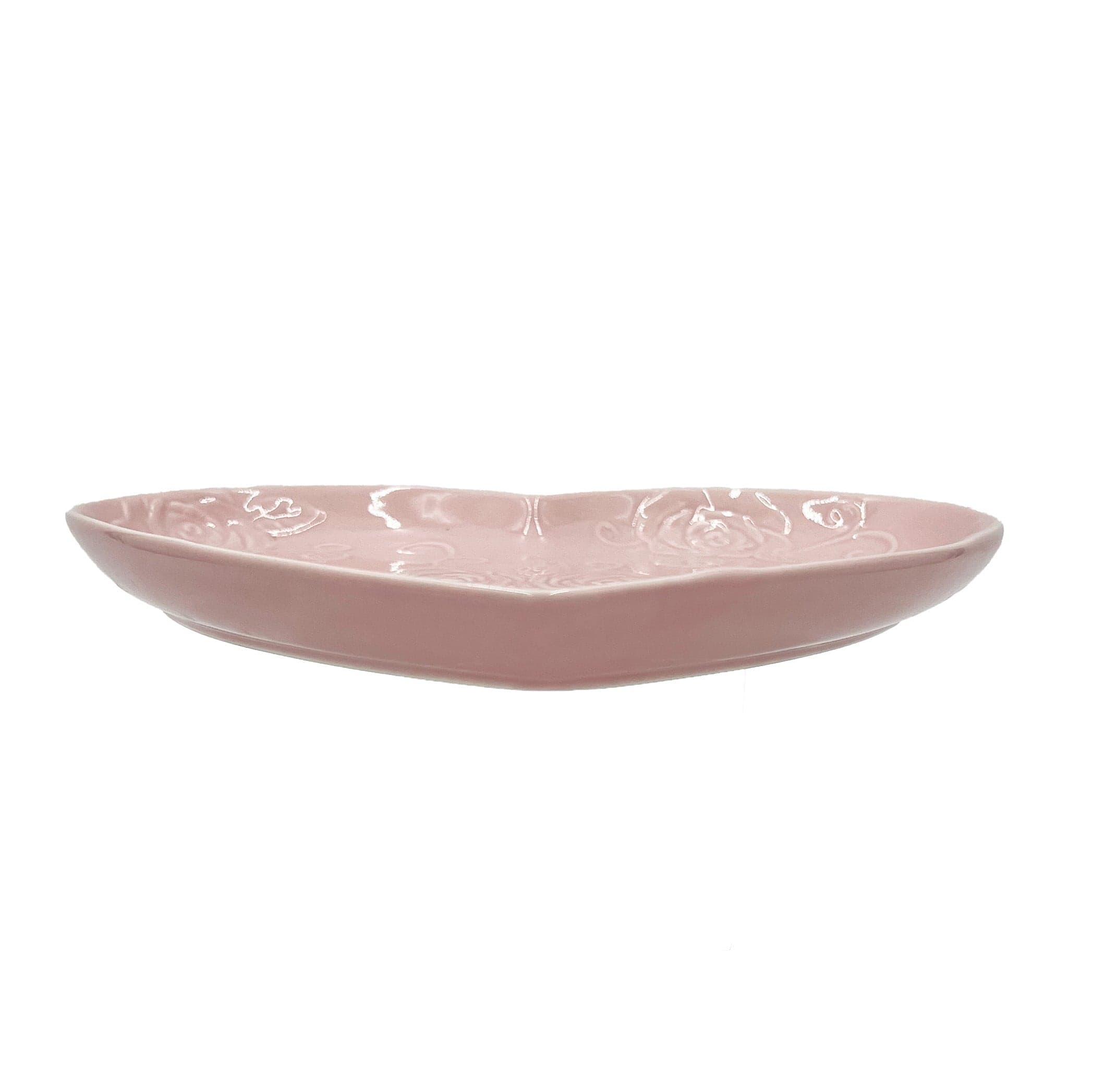 Pink heart plate being used to serve desserts at a romantic dinner