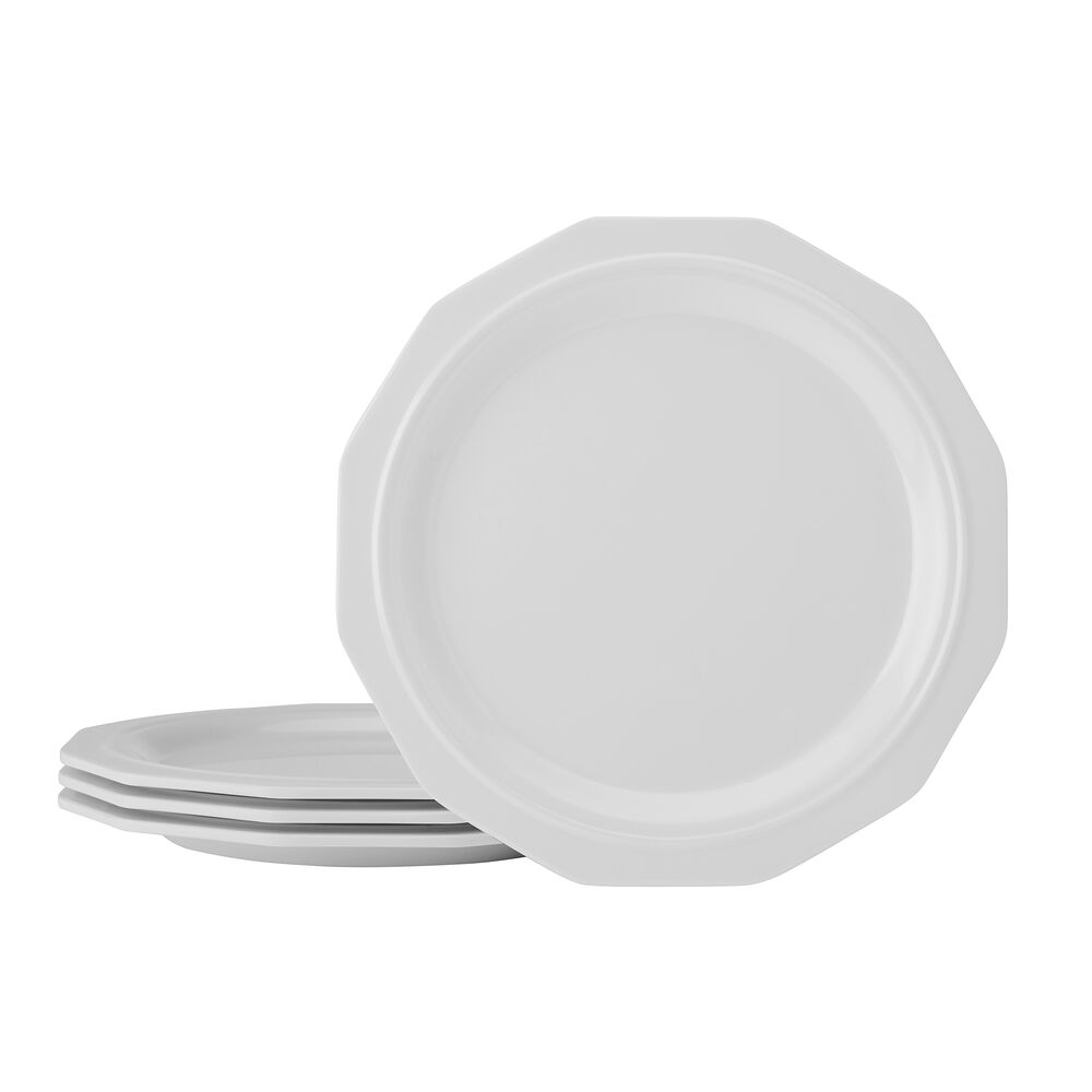 Set of four melamine salad plates placed on a picnic table with fresh salad.