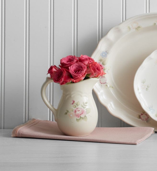 Porcelain sugar bowl and creamer set with utensils on a breakfast buffet