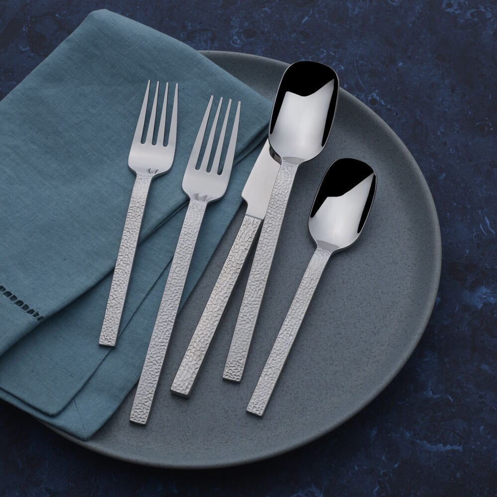 Elegant modern flatware set displayed on a dining table, perfect for formal dining.