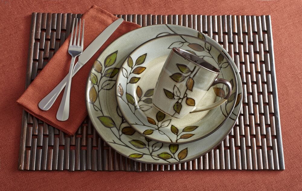 Rustic Leaves stoneware dinnerware set for 8 with plates and bowls on a rustic table