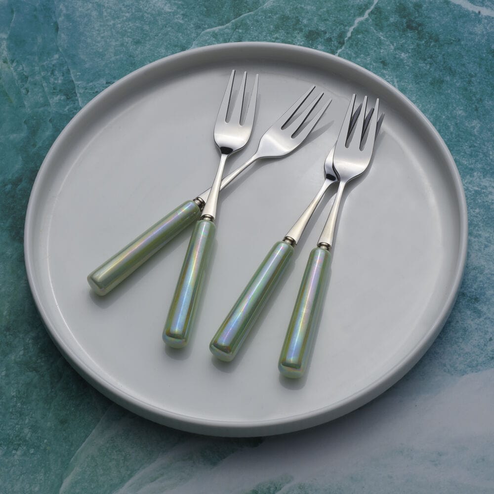 Ceramic handle appetizer forks arranged on a dinner table, stylish flatware for entertaining