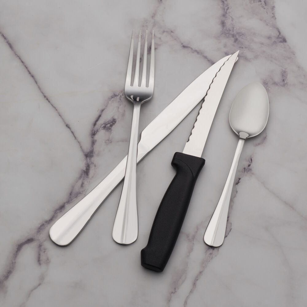Kitchen scene featuring the flatware set being washed in a dishwasher
