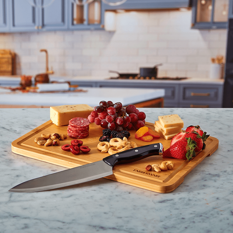 Person using the reversible cutting board lid for food prep on the go