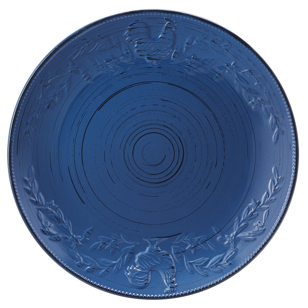 Close-up of blue stoneware dinner plate with rustic rooster design