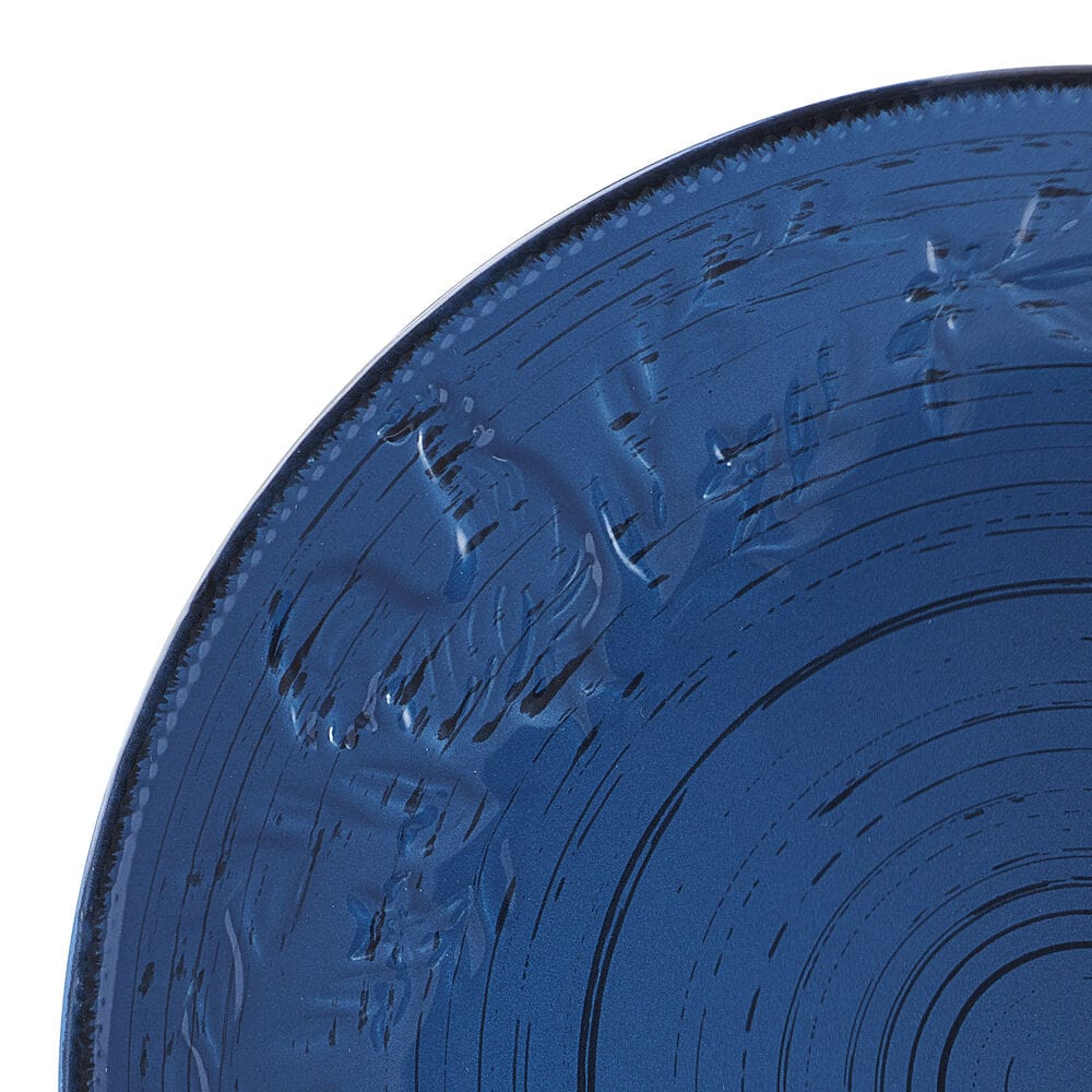 Close-up of blue stoneware dinner plate with rustic rooster design