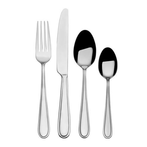 Close-up of stainless steel dinner forks and spoons from the flatware set.