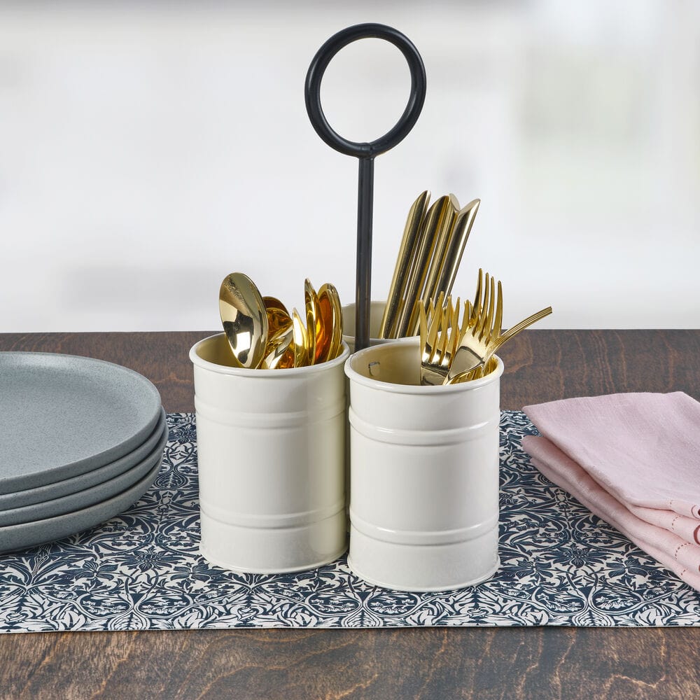 Close-up of white metal storage caddy with utensils inside, highlighting the compartments