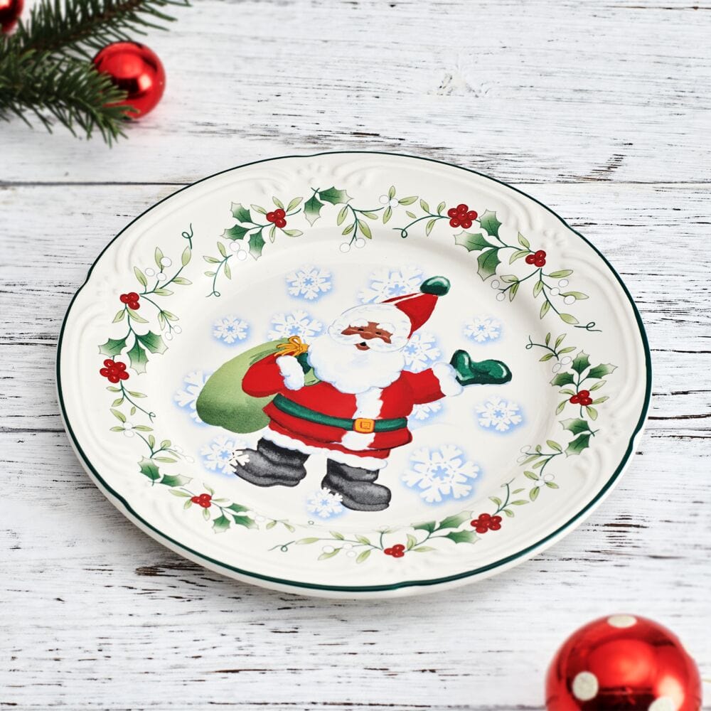 Overhead angle showing all four Christmas salad plates arranged for dinner service with holiday decor.