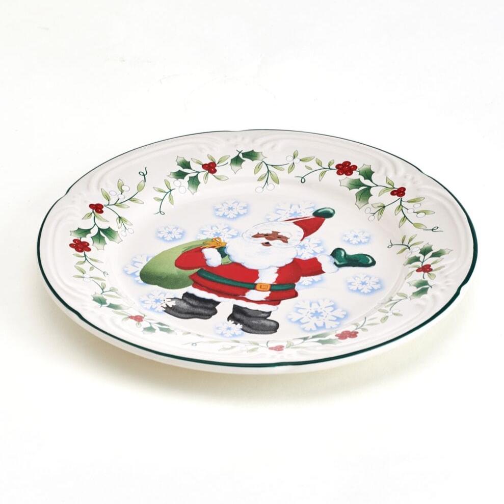Overhead angle showing all four Christmas salad plates arranged for dinner service with holiday decor.
