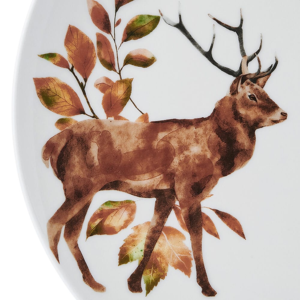 Detailed view of deer, duck, and fox illustrations on ceramic dinnerware pieces