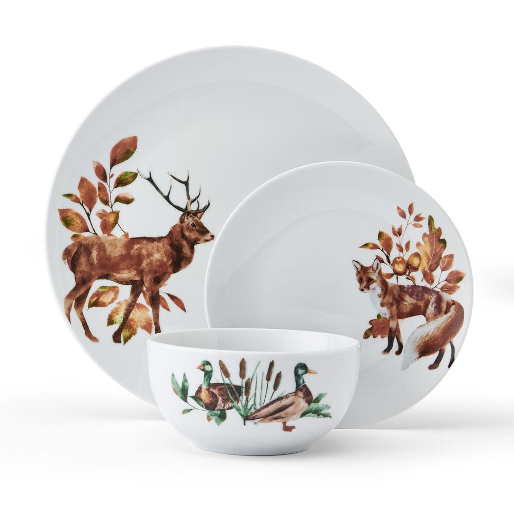 Close-up of woodland animal ceramic dinnerware set for 4 on a rustic table