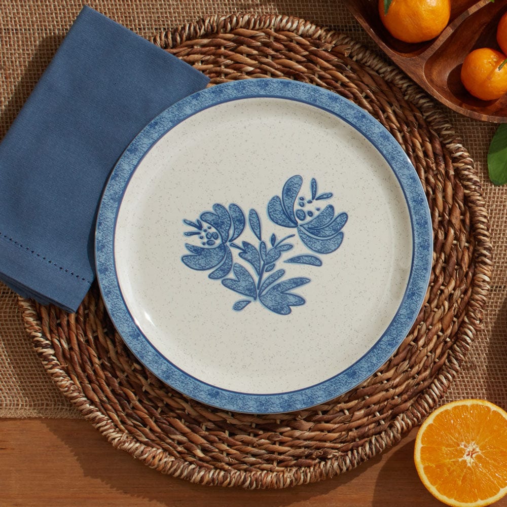 Yorktowne outdoor melamine dinnerware set displayed on a picnic table, featuring dinner and salad plates with vibrant colors.