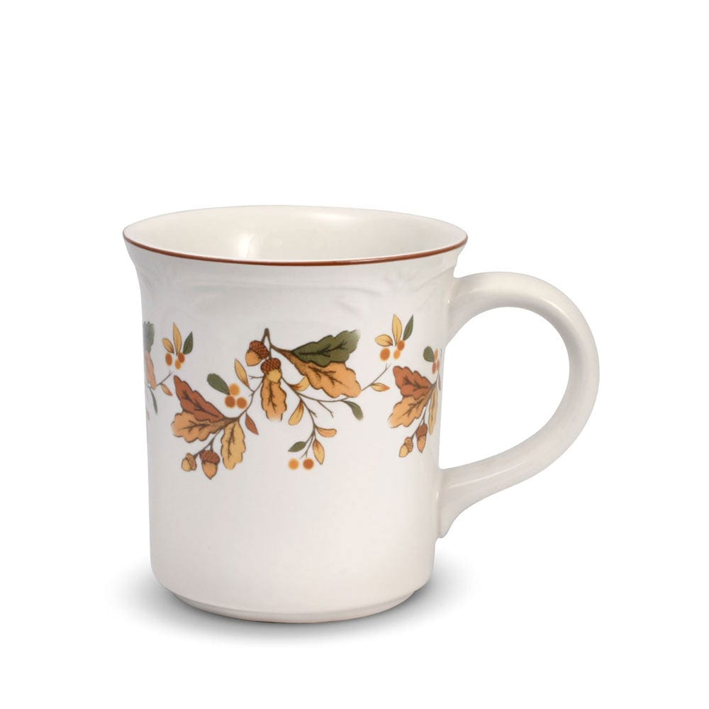 Person holding a large stoneware coffee mug filled with hot beverage