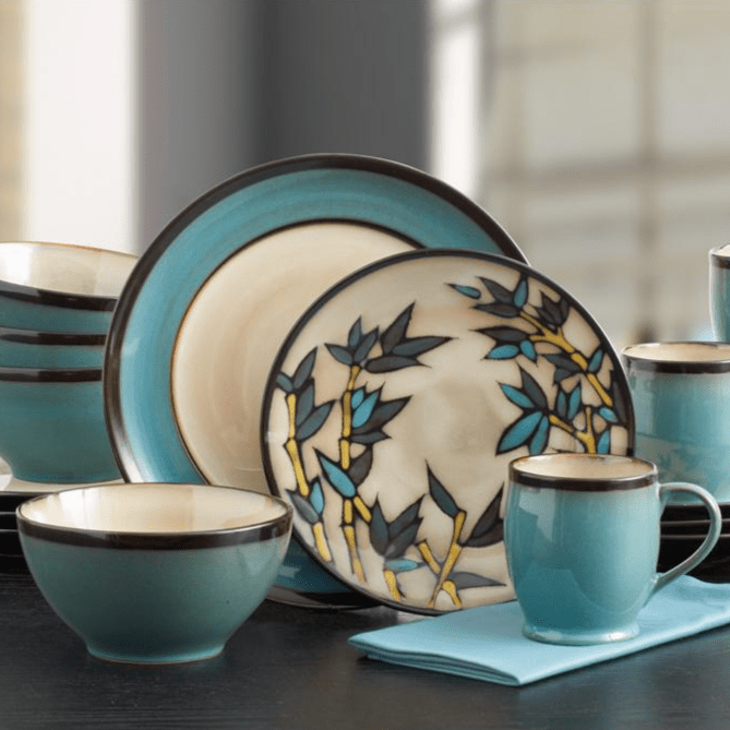 Close-up of handcrafted blue dinnerware with reactive glaze finish