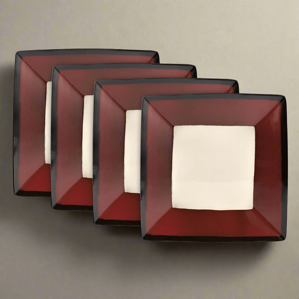 A close-up of Belmont red stoneware square dinner plates showcasing the unique reactive glaze.