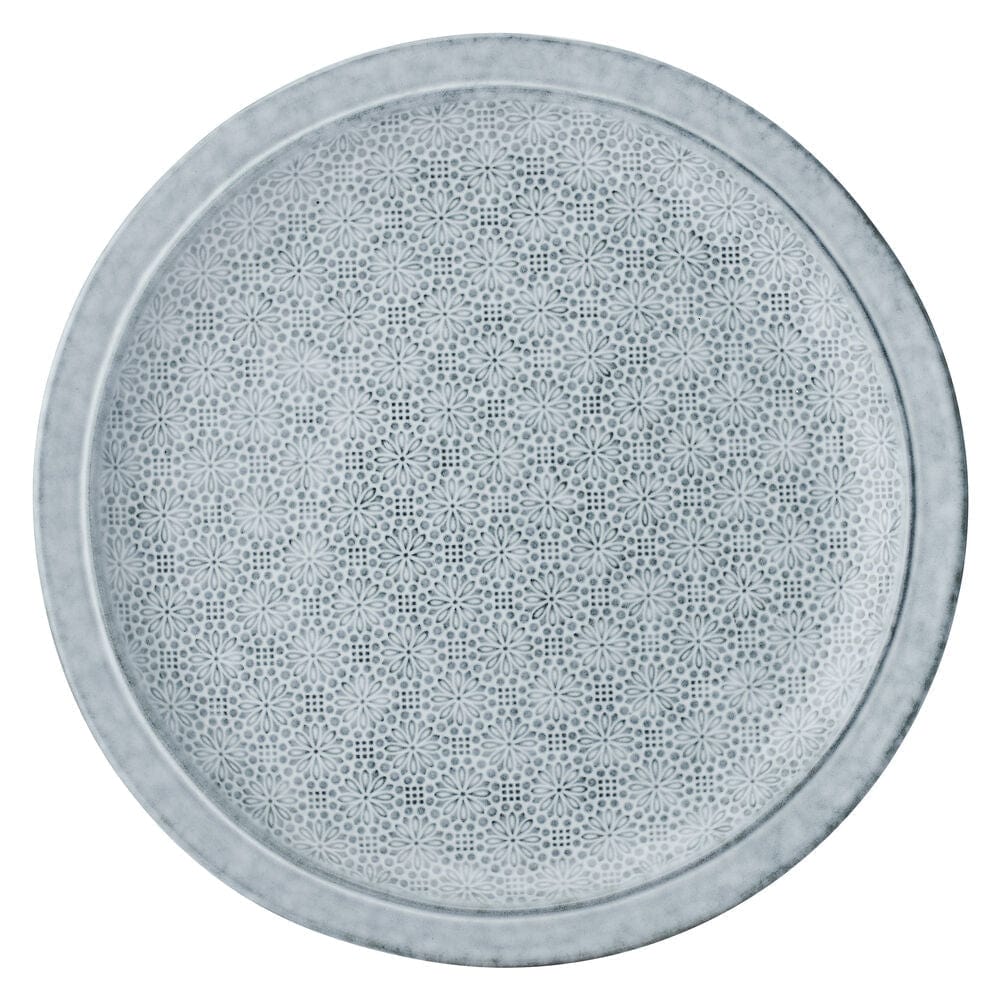 Close-up of blooming floral design on blue dinnerware set for 4