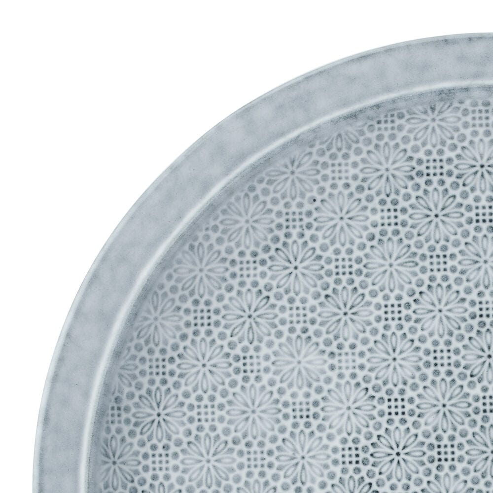 Close-up of blooming floral design on blue dinnerware set for 4
