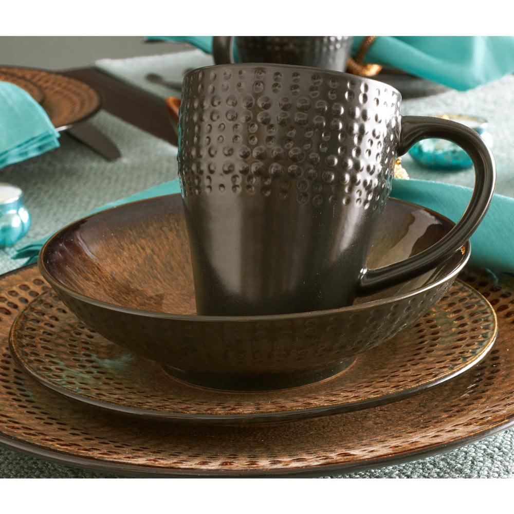 Close-up of stoneware dishes in the dinnerware set, highlighting the intricate reactive glaze patterns and textures.