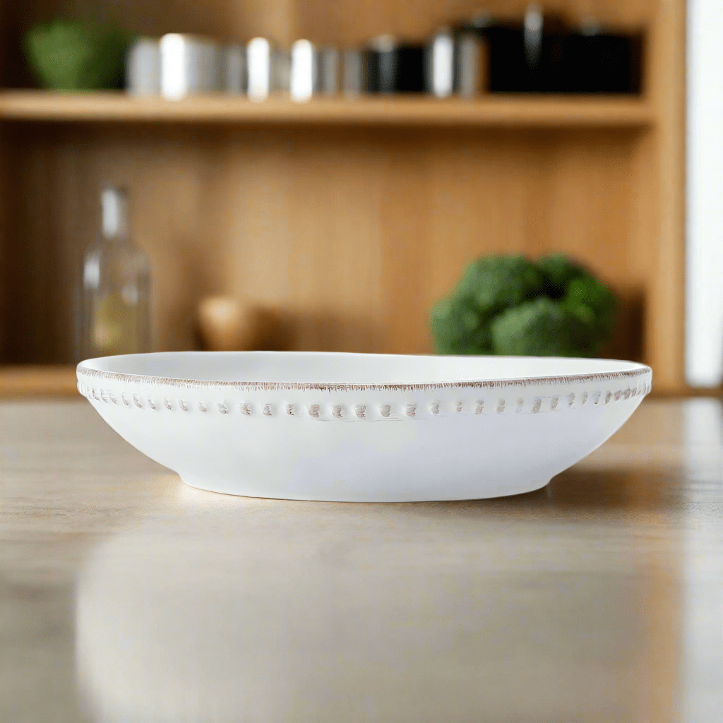Close-up of the warped shape and beaded rim of the stoneware pasta bowl