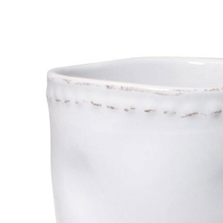 Set of 4 vintage stoneware coffee mugs on kitchen counter
