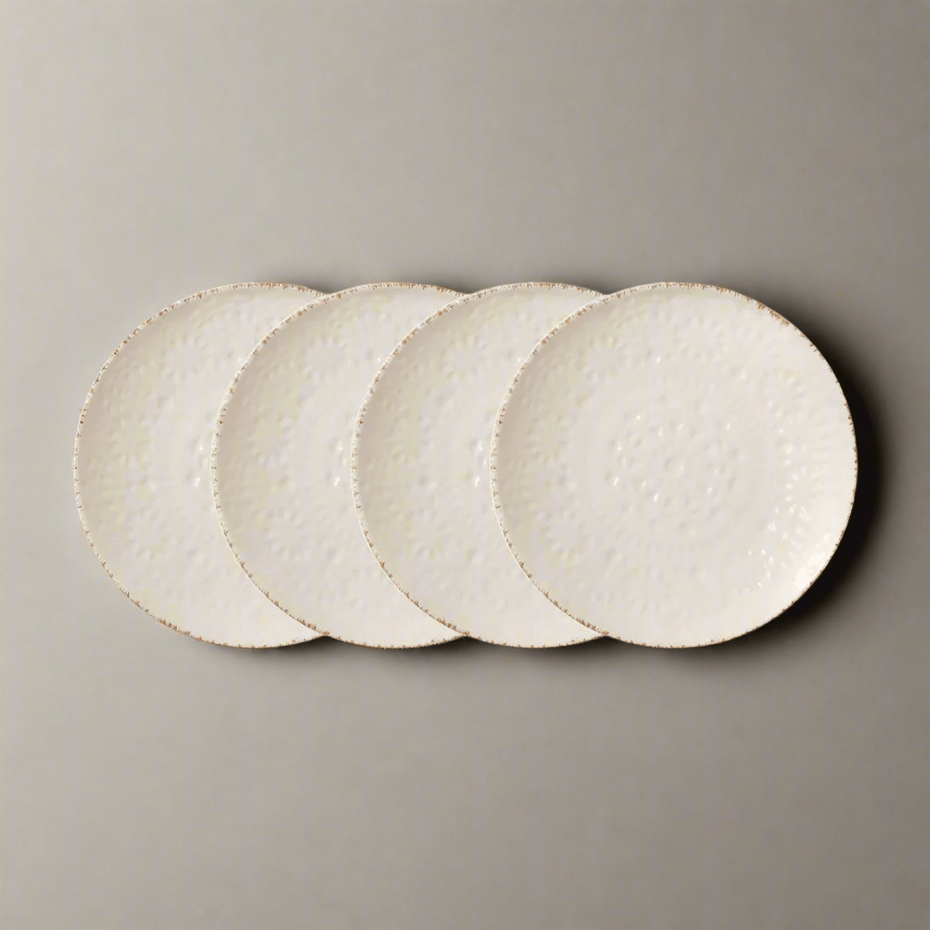 Overhead view of cream stoneware appetizer plates with lace texture, ideal for stylish serving
