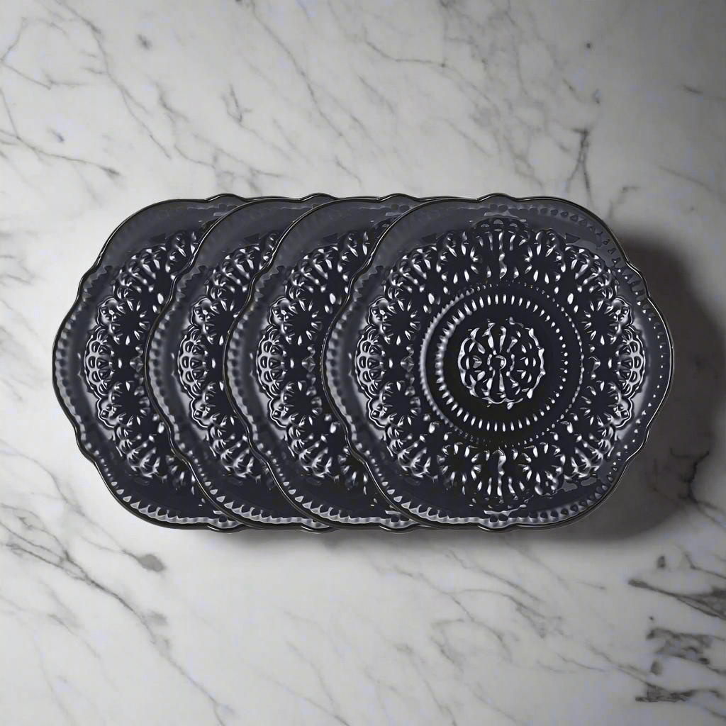 Chateau Midnight Salad Plate Set displayed on a dining table, featuring lace design and scalloped edges.