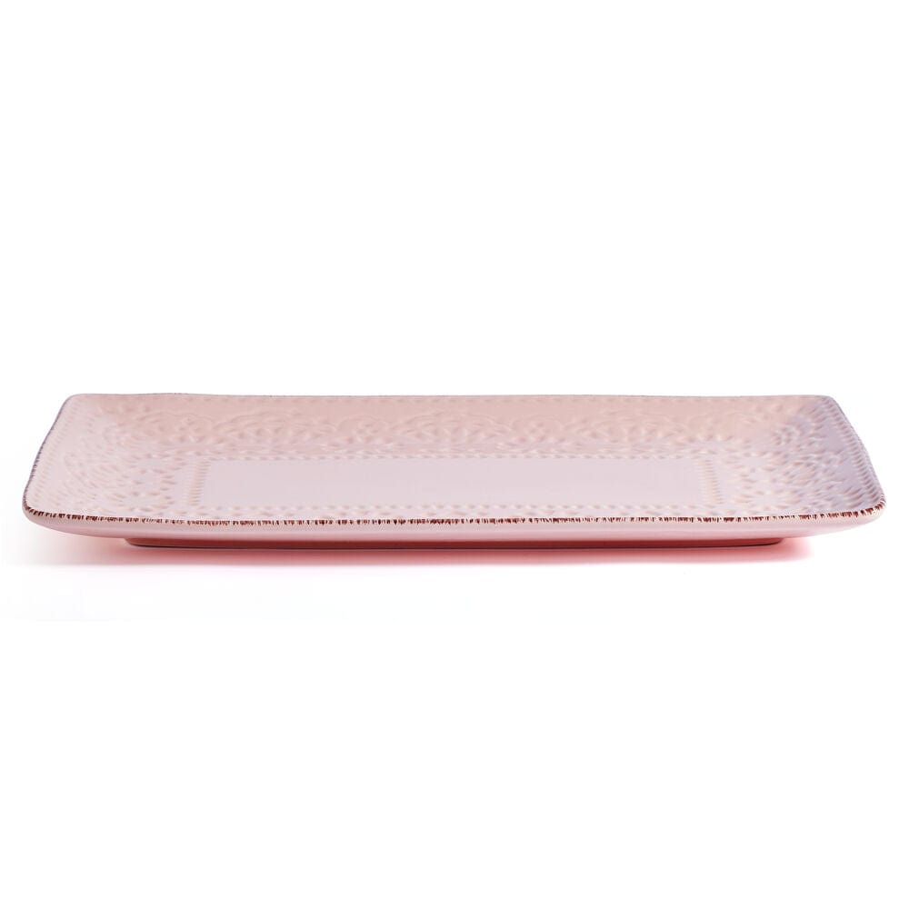 Large pink serving platter displayed with appetizers at a festive party