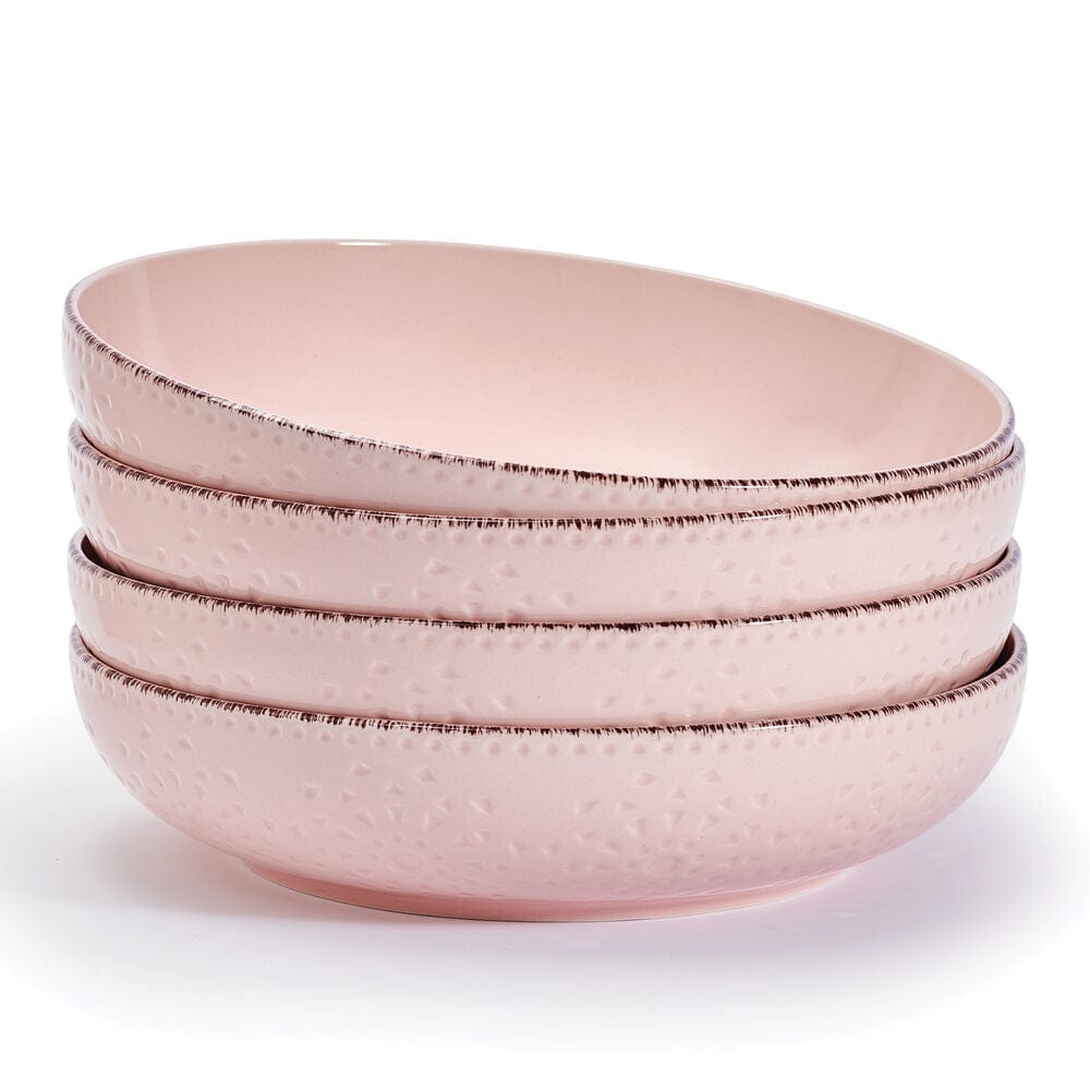 Close-up of stoneware pasta bowl showcasing its dimpled lace design and pink hue