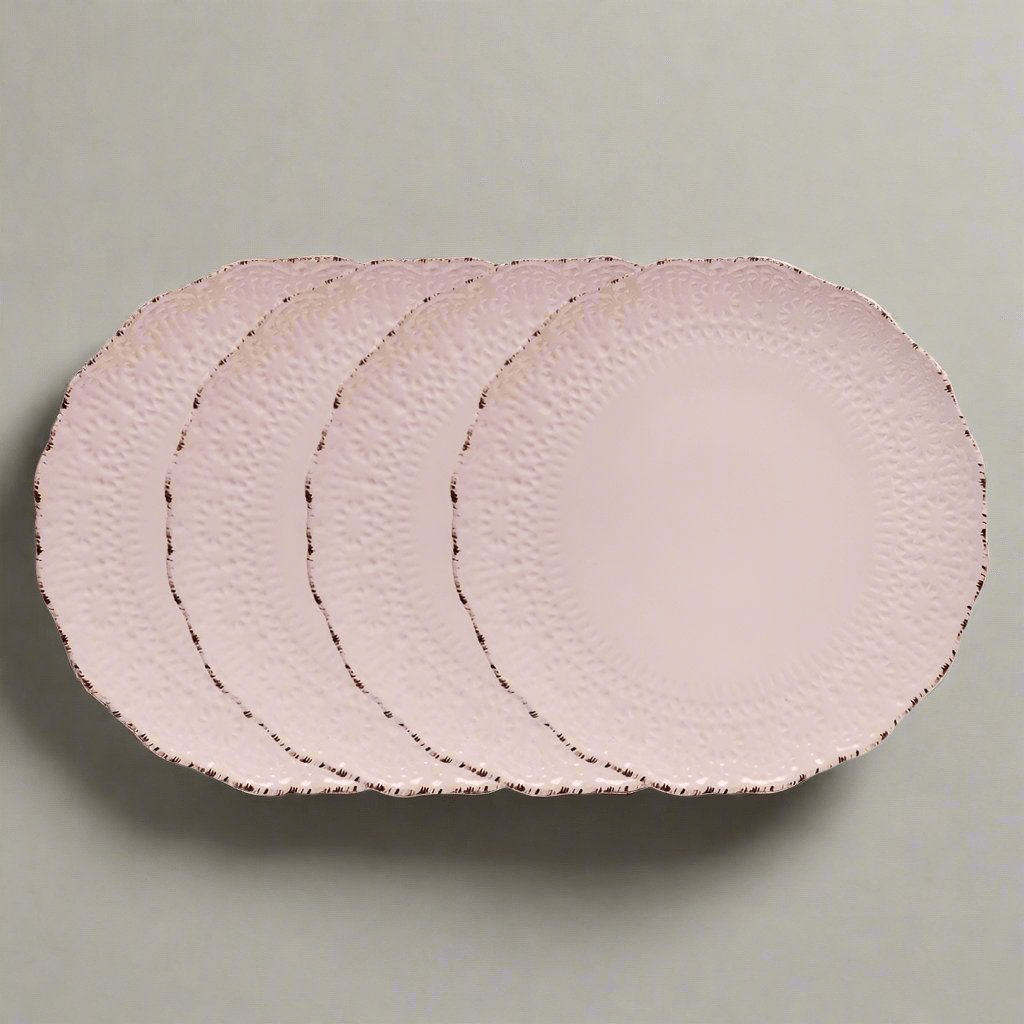 Close-up of pink stoneware dinner plate with lace pattern and scalloped edge, perfect for formal dining