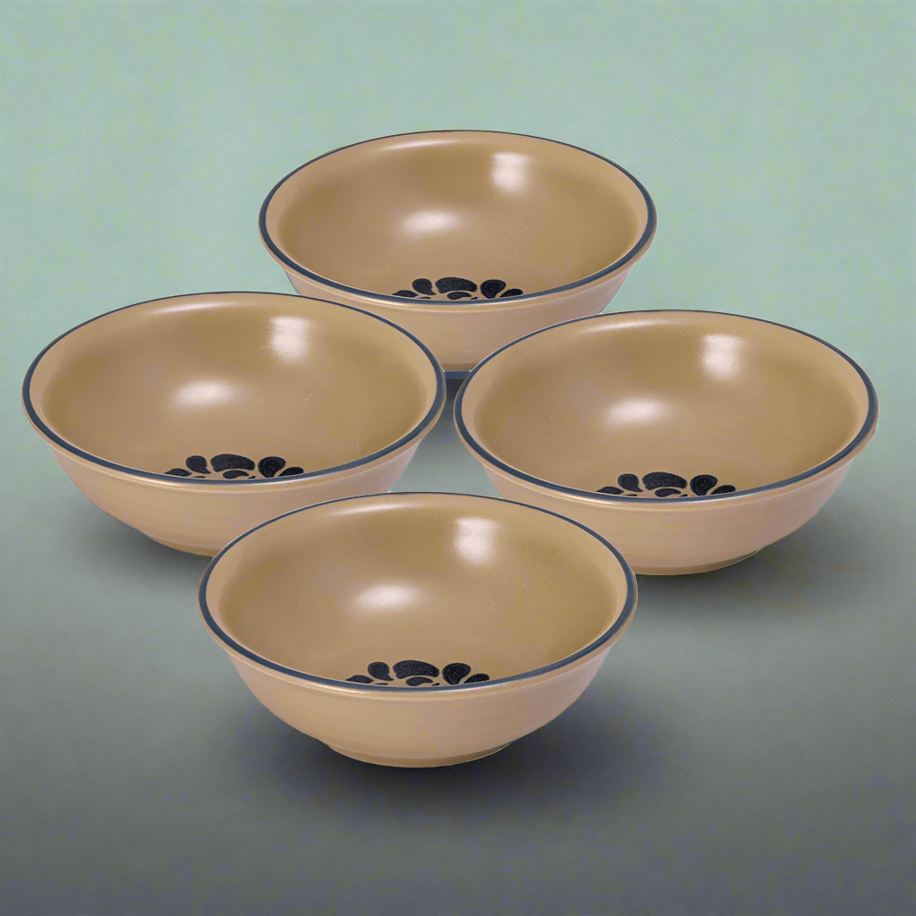 Set of four stoneware soup and cereal bowls stacked on a kitchen table