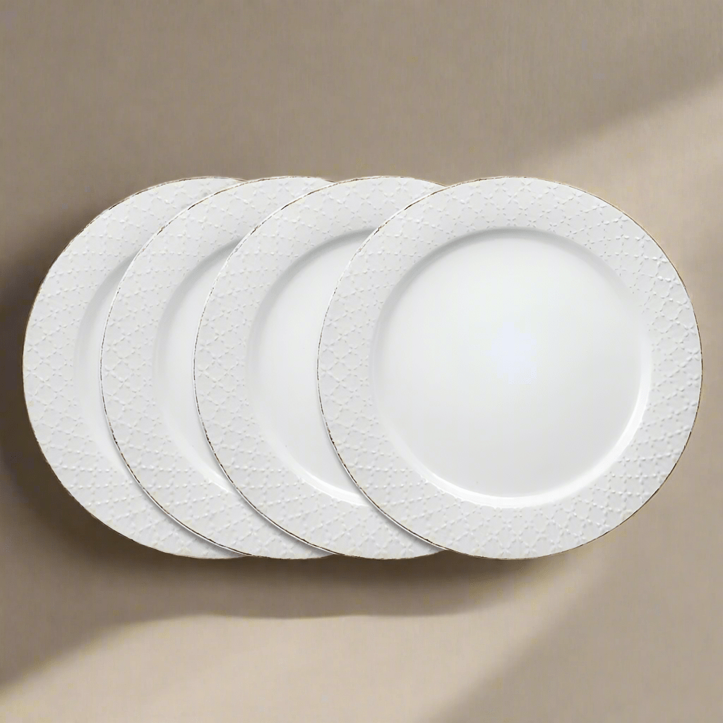 Close-up of white stoneware dinner plates with lace design for formal dining