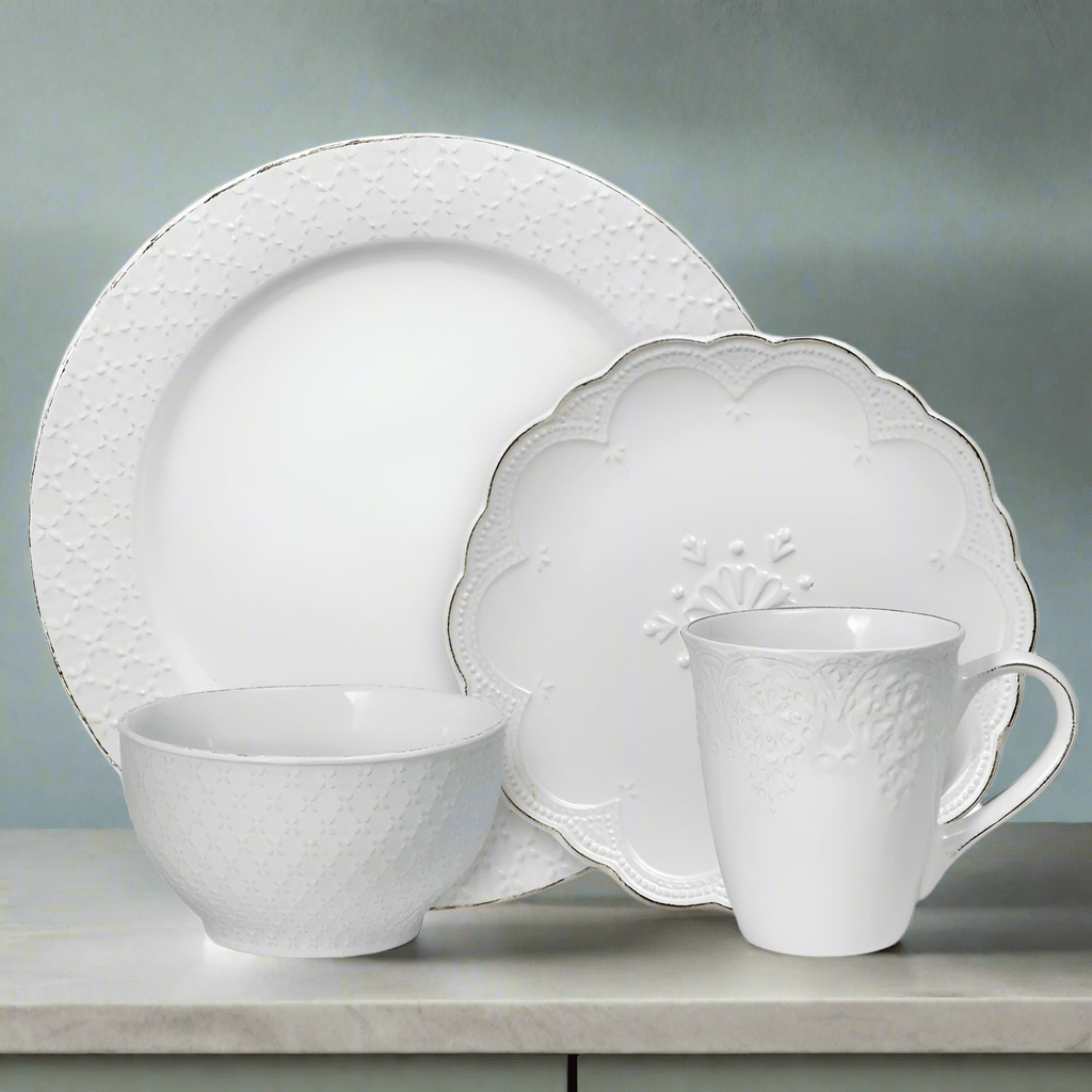 Close-up view of the elegant stoneware dinner set showcasing the intricate French lace design.