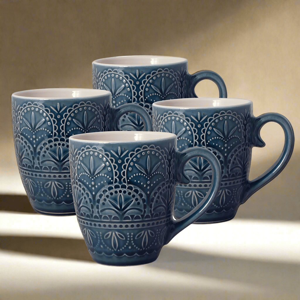 A close-up of the Havana set of unique coffee mugs showcasing the embossed pattern and jeweled tone blue glaze.