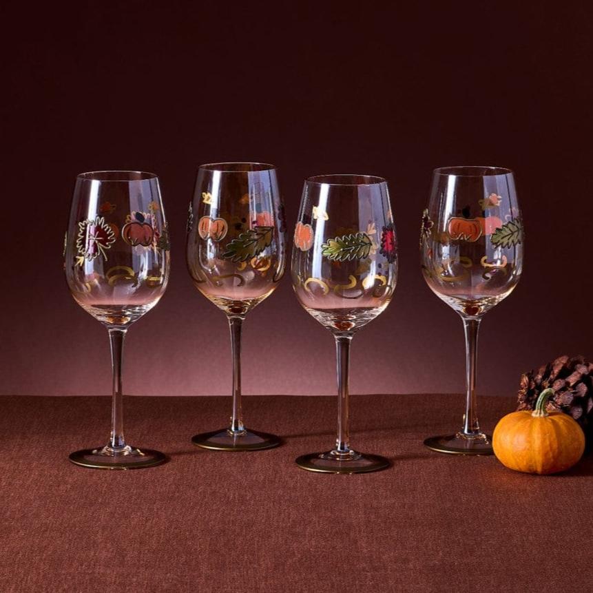 Close-up of hand-painted leaf luster wine glasses with autumn leaf design