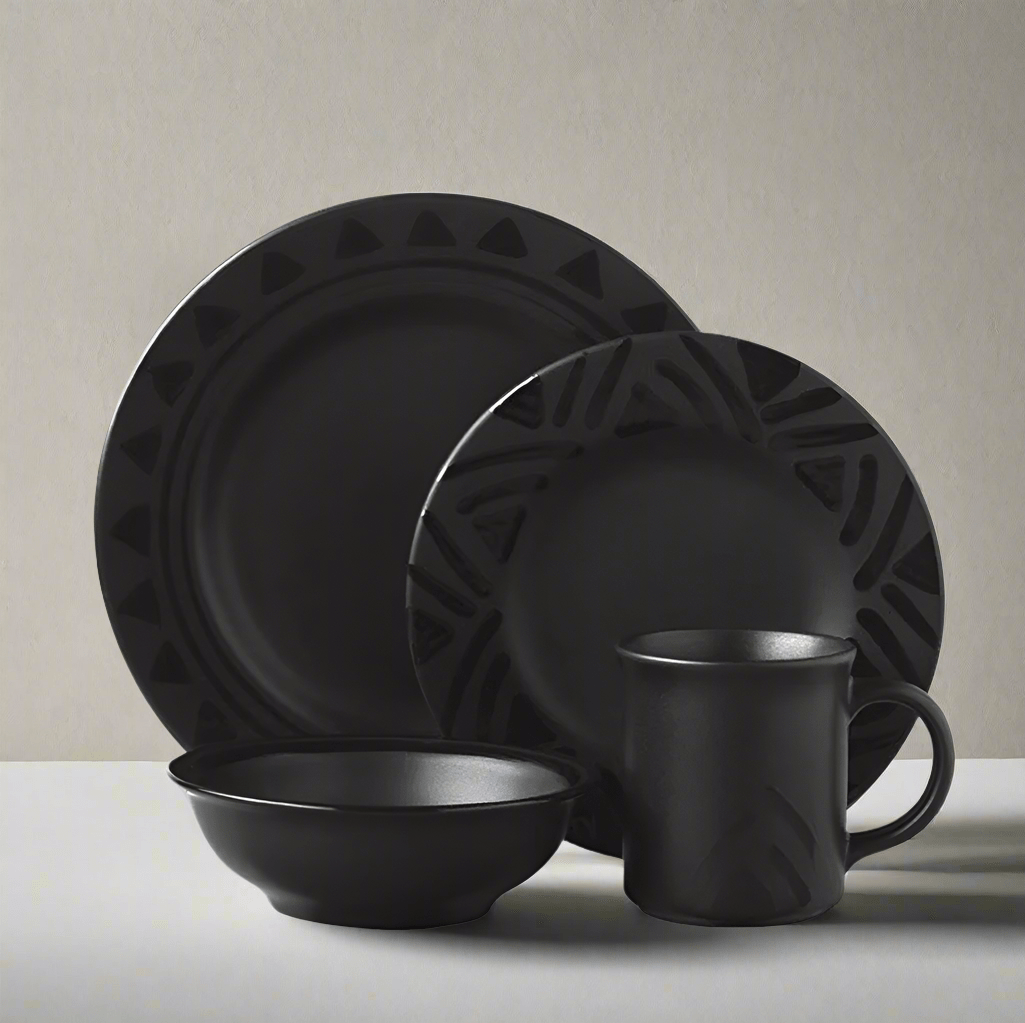 Midnight Sun stoneware dinnerware set displayed on a dining table, showcasing dinner plates and bowls