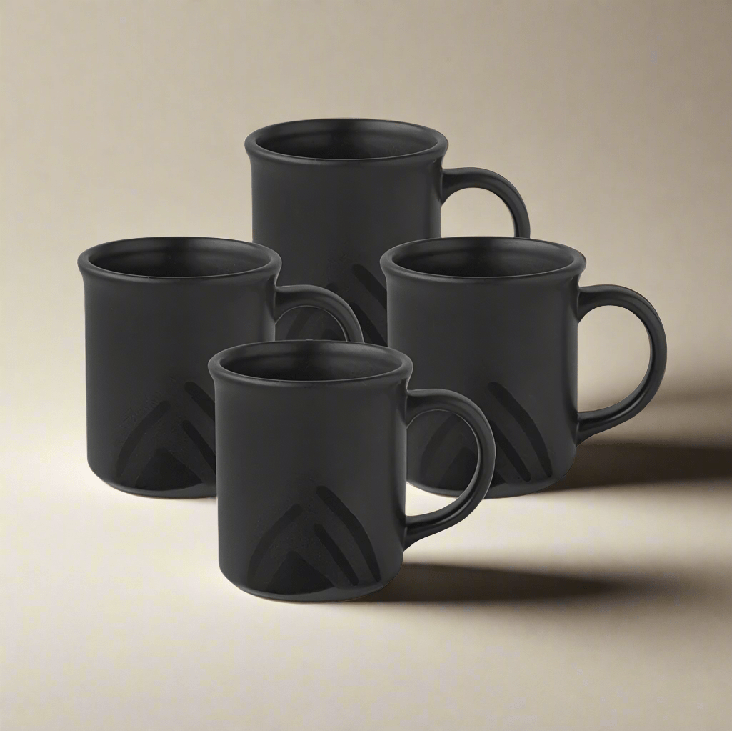 Midnight Sun coffee mug set displayed with steaming tea and coffee