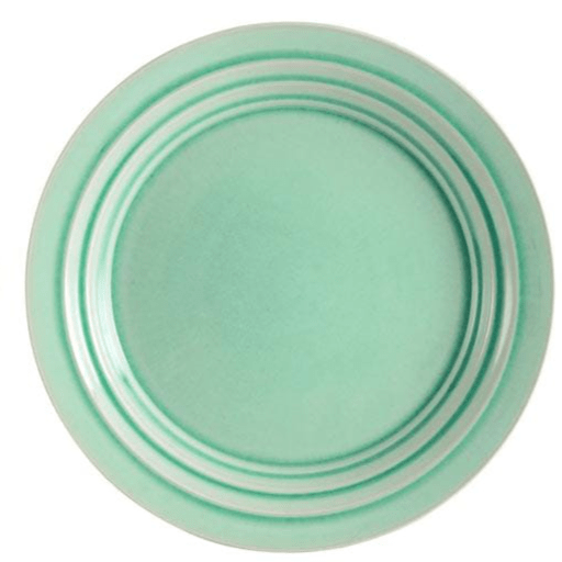 Front profile of stoneware serving platter with watercolor accents, styled with grilled meat and herbs.