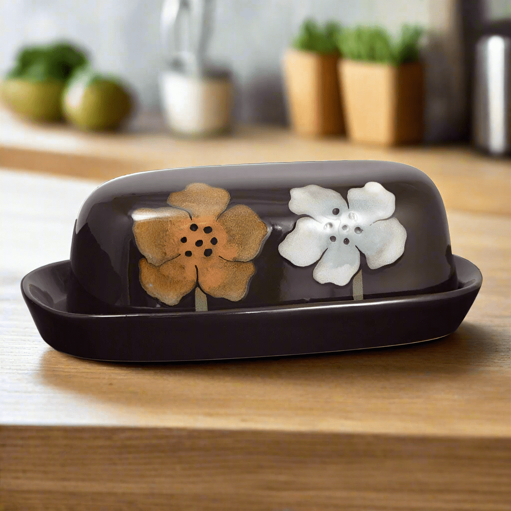 Charming stoneware butter dish showcasing unique reactive glaze, perfect for dining table