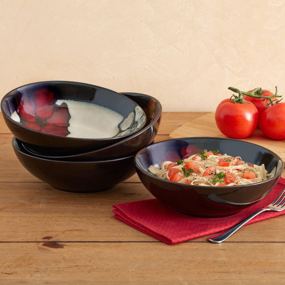Vibrant stoneware pasta salad bowl set showcasing unique patterns and colors.