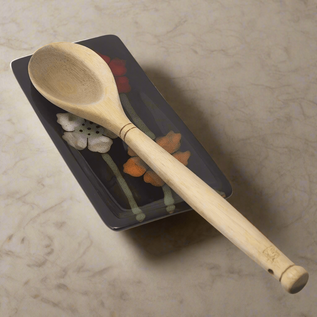 Close-up of painted poppies on ceramic spoon rest for kitchen use
